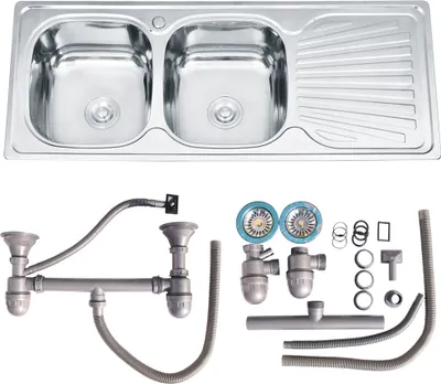 A stainless steel double sink with drainer and plumbing accessories, presented on a white background.