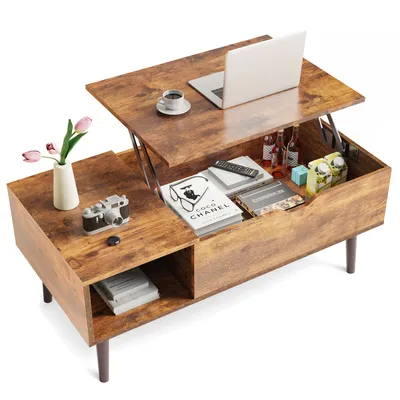 A lift-top coffee table with various items on and inside it, including a laptop, books, and drinks.