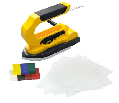 A yellow and black encaustic iron with a set of colored wax blocks and white paper sheets on a white background.