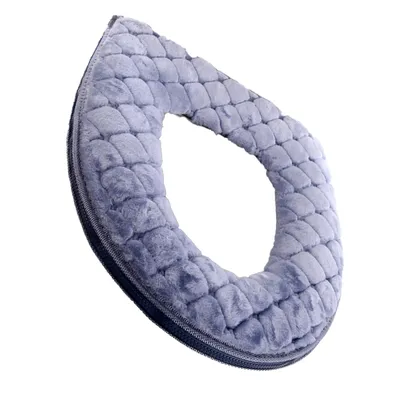 A close-up, angled view of a light blue, plush toilet seat cover against a white background.