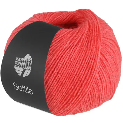 A ball of coral-colored yarn with a black label wrapped around it.