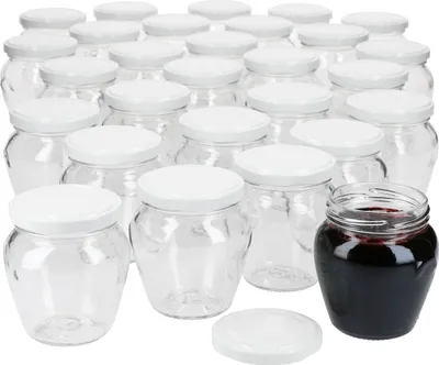 A collection of empty glass jars with white lids, and one jar filled with dark red jam or preserves.