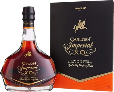 A bottle of Osborne Carlos I Imperial Brandy de Jerez Solera Gran Reserva and its gift box are displayed against a white background.