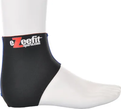A black and white ankle bootie on a white mannequin foot.