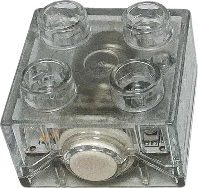 A clear studio shot of a transparent LEGO DUPLO light brick.