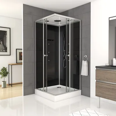 A modern bathroom with a black glass shower cabin.