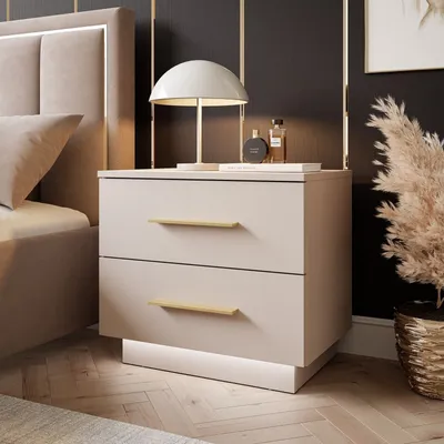 A bedroom scene featuring a nightstand next to a bed.