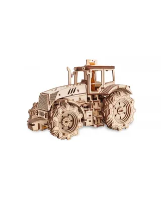 A wooden model tractor on a white background.