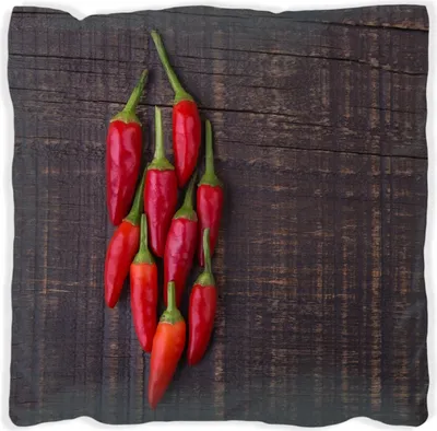 Produktbild von Wallario Premium Kissen, weiche Oberfläche, mit Motiv Rote Paprikaschoten auf einem dunkelbraunem Holzbrett, Größe: 30 x 30 cm, mit weißer Rückseite