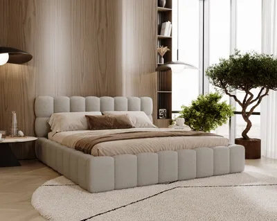 A modern bedroom with a light gray upholstered bed, wooden wall paneling, and a large window with a tree.