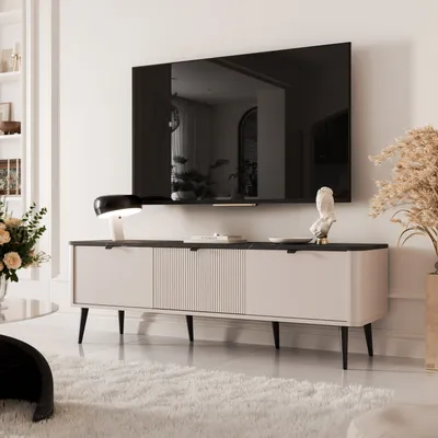 A modern living room with a TV mounted on the wall above a TV stand.