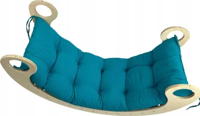 A teal cushion on a wooden rocking base.