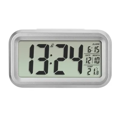 A digital alarm clock with a silver frame and a green display showing the time, date, alarm, and temperature.