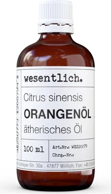 A bottle of orange essential oil with a label.
