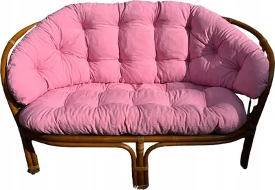 A pink cushion set for a rattan garden sofa, shown against a white background.