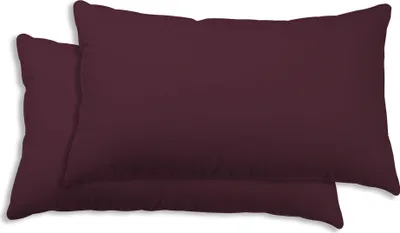 Two burgundy pillows are stacked on top of each other.