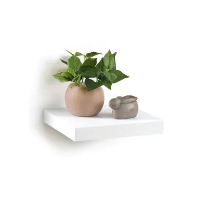 A white floating shelf with a potted plant and a small decorative bunny.