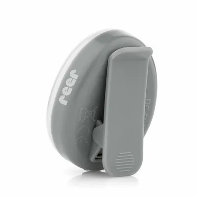 A close-up side view of a gray and white reer ClipLight Stilllicht with a clip attached.