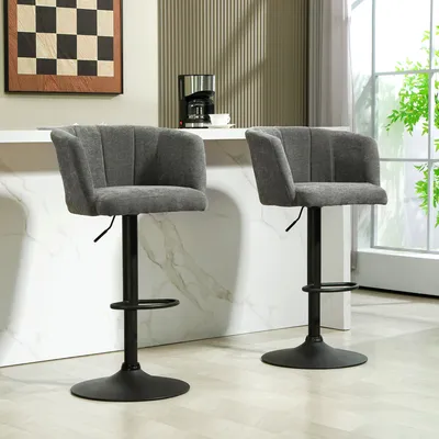 Two gray bar stools are shown in a modern kitchen setting, with a countertop and a window in the background.