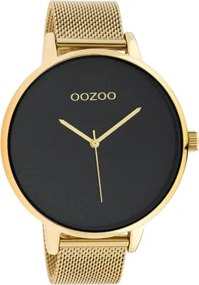 A close-up studio shot of a gold and black wristwatch.