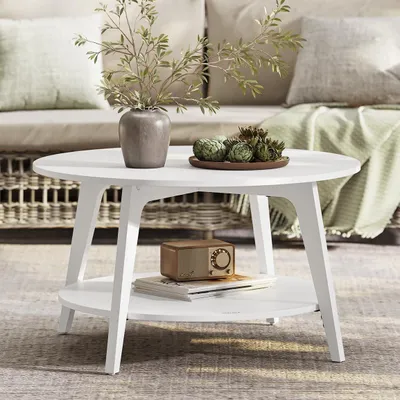 A white coffee table with decorative items on it, placed in a living room setting with a sofa in the background.