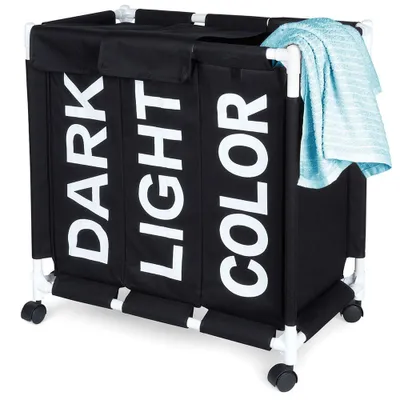 A black laundry basket with three compartments labeled 'DARK', 'LIGHT', and 'COLOR'. It has a white frame and wheels, and a blue towel is draped over the top right corner.