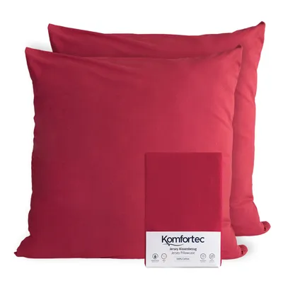 Two red pillowcases are shown, with one folded and a label on it.