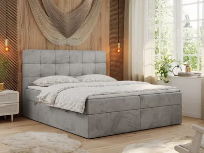 A bedroom scene with a large bed as the focal point, decorated with soft lighting and natural elements.