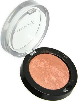A makeup blush compact with the lid open, showing the product inside.