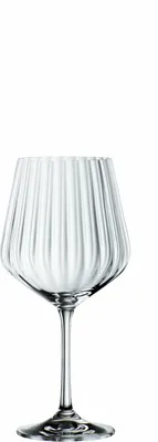 A clear glass cocktail glass with vertical ridges.