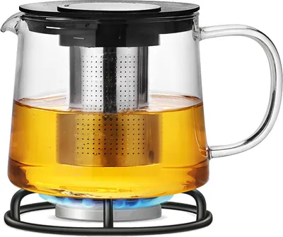 A glass teapot filled with tea, placed on a black stand over a blue gas flame.