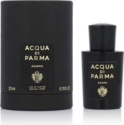 A black perfume bottle and its packaging are displayed against a white background.
