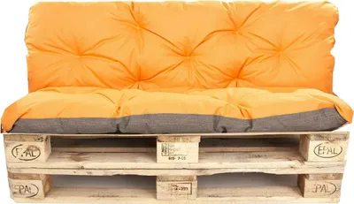 A pallet sofa with orange cushions.