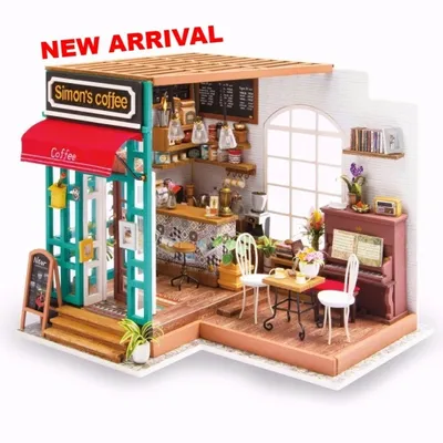 A miniature dollhouse cafe scene with a coffee shop front and interior.