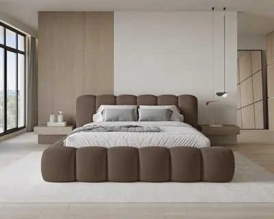 A modern bedroom with a large upholstered bed.