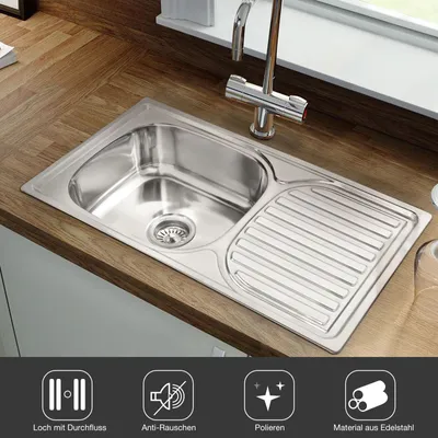 A stainless steel kitchen sink with a faucet is shown on a wooden countertop, with icons and text below highlighting product features.