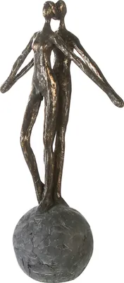 A bronze-colored sculpture of two figures embracing, standing on a round base.