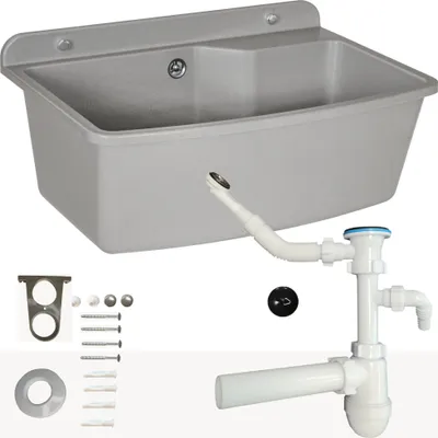 A grey washbasin with plumbing accessories laid out below it.