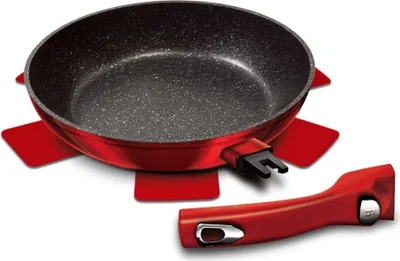 A red frying pan with a detachable handle and a red trivet, photographed against a white background.