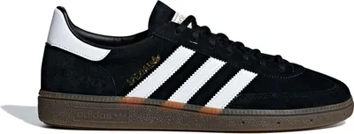 A black Adidas sneaker with white stripes and a brown sole, shown from the side against a white background.