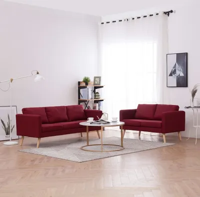 A living room scene with two red sofas and a coffee table.