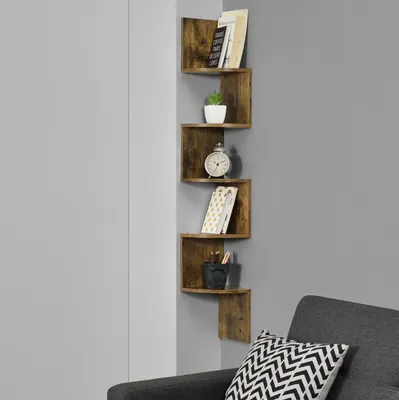 A corner shelf unit with books, a plant, and an alarm clock.