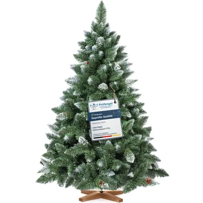 A decorated artificial Christmas tree with a tag attached.