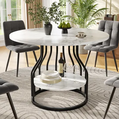 A round dining table with chairs in a dining room setting.