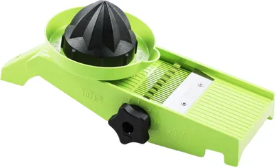 A green and black vegetable slicer with a citrus juicer attachment on a white background.