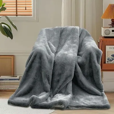 A plush blanket draped over a chair in a living room setting.
