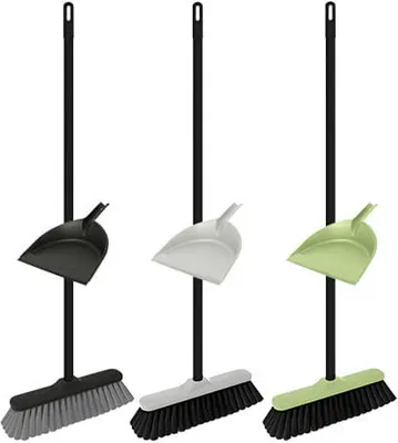 Three brooms with dustpans in different colors.