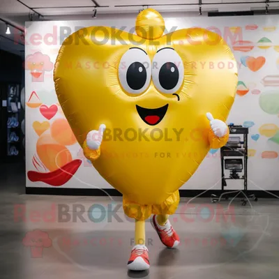 Productafbeelding van Gouden hartvormige ballonnen mascotte REDBROKOLY kostuum karakter gekleed met een hardloopbroek en koerierstassen