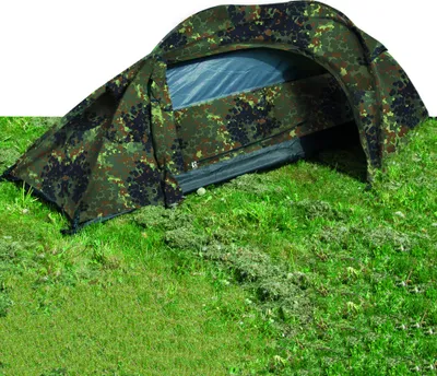 A camouflage tent set up on grass.