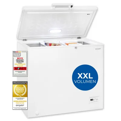 A white chest freezer with its lid open, showing internal compartments and some frozen food items. Several award badges are attached to the front left side of the freezer, and a blue circle with text is on the front right.